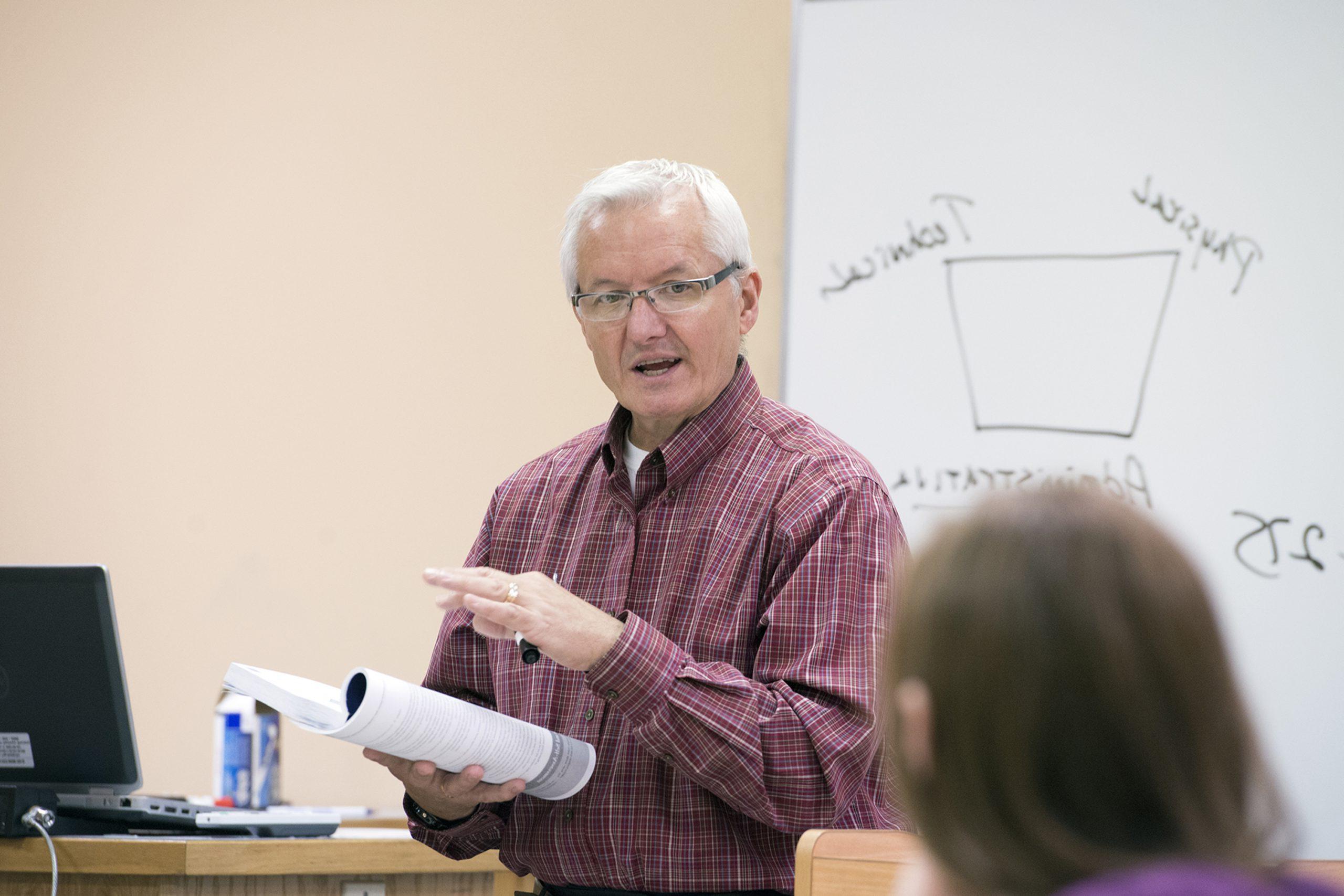 Dr. William Graves Teaching on a white board